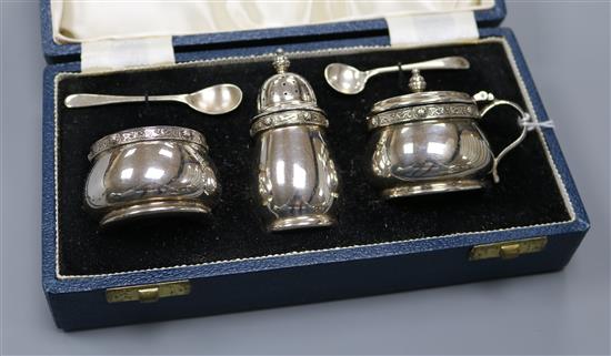 A cased 1960s Mappin & Webb three piece silver condiment set decorated with Celtic band, Sheffield, 1969.